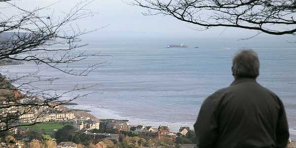 Back of man looking out to sea